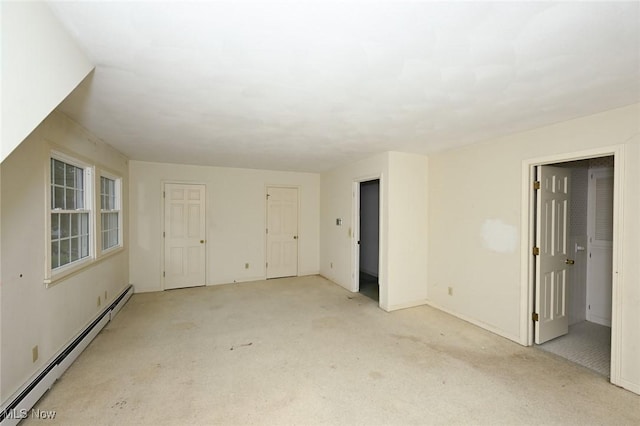 carpeted empty room featuring baseboards and baseboard heating