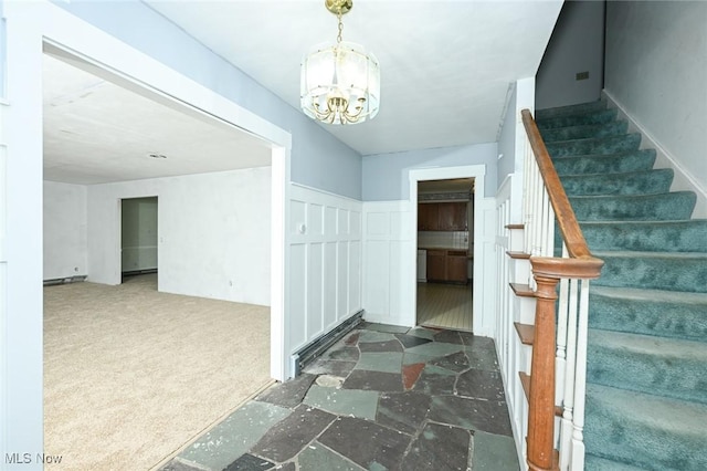 interior space featuring stairway and a notable chandelier