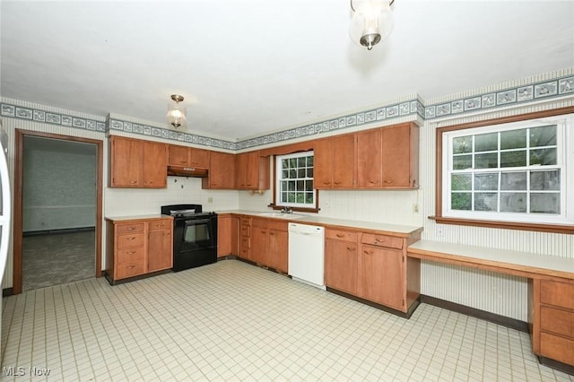 kitchen featuring a sink, black range with electric cooktop, light countertops, and white dishwasher