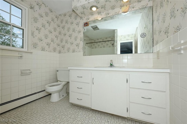 full bath with wallpapered walls, a baseboard radiator, tile walls, wainscoting, and vanity