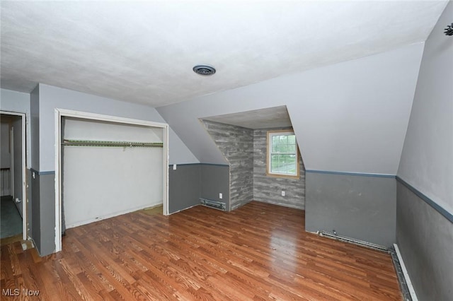 bonus room with vaulted ceiling and wood finished floors