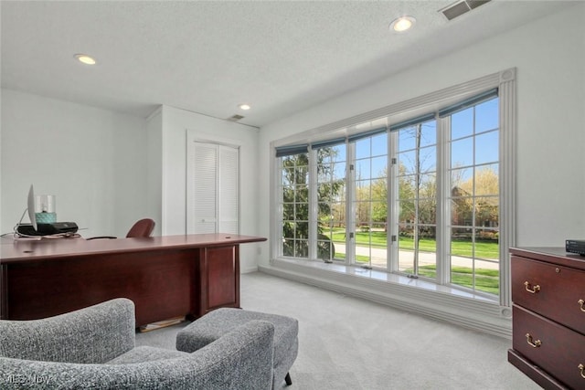 office space featuring baseboards, recessed lighting, light carpet, and visible vents