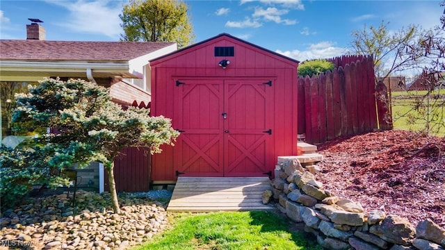 view of shed featuring fence