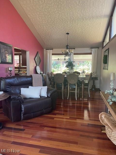 living room featuring a textured ceiling, a healthy amount of sunlight, and wood finished floors