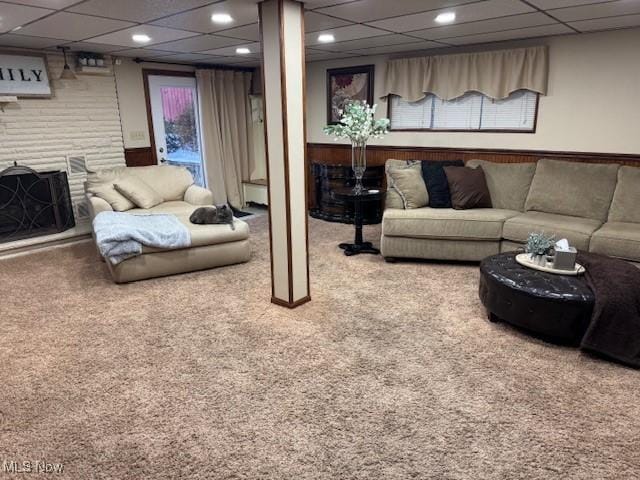 carpeted living room featuring a paneled ceiling