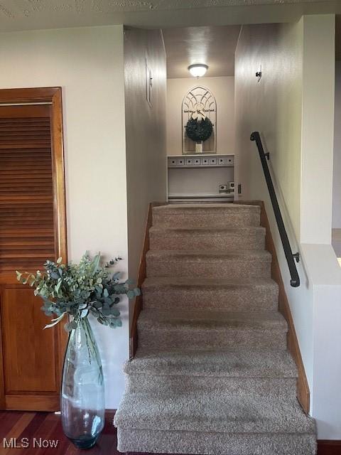 stairs featuring wood finished floors