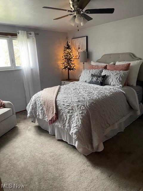 carpeted bedroom featuring ceiling fan