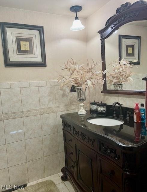 bathroom featuring tile walls, tile patterned flooring, and vanity