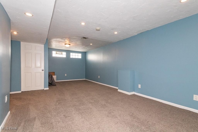 basement featuring baseboards, visible vents, recessed lighting, and carpet floors