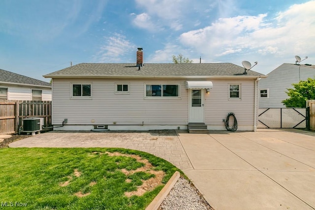 rear view of property with central AC, fence, a lawn, a patio area, and entry steps