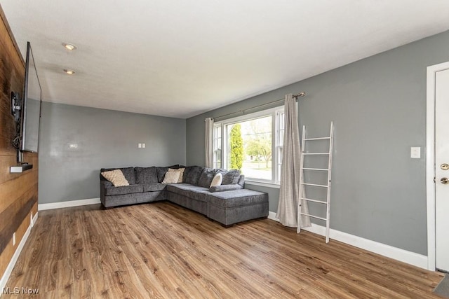 living room featuring baseboards and light wood-type flooring