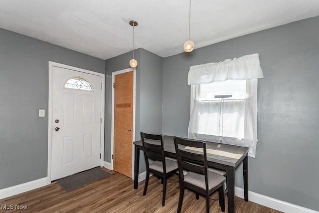entrance foyer featuring baseboards and wood finished floors