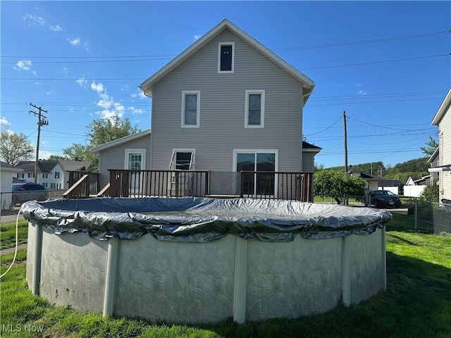 1905 Pine St SE, East Sparta, OH 44626 - rear view of property with a yard, a deck, a fenced in pool, and fence
