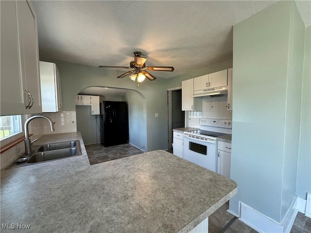 1905 Pine St SE, East Sparta, OH 44626 - kitchen featuring a peninsula, a sink, white cabinetry, arched walkways, and white range with electric stovetop