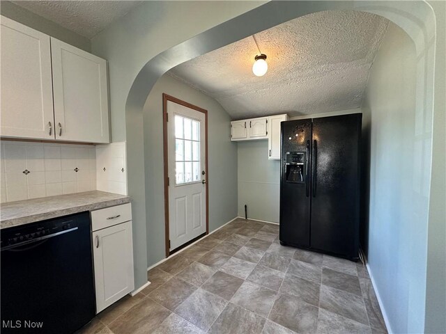 1905 Pine St SE, East Sparta, OH 44626 - kitchen featuring backsplash, a textured ceiling, white cabinetry, arched walkways, and black appliances
