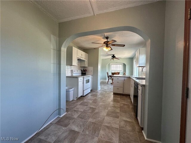 1905 Pine St SE, East Sparta, OH 44626 - kitchen with a sink, a textured ceiling, ceiling fan, arched walkways, and white electric stove