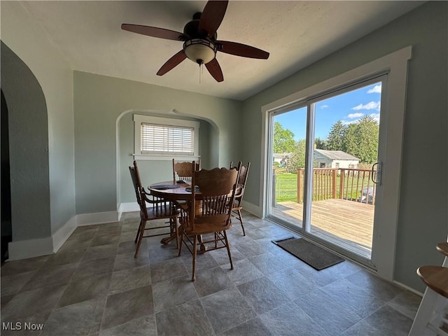 1905 Pine St SE, East Sparta, OH 44626 - dining area with arched walkways, baseboards, ceiling fan, and plenty of natural light