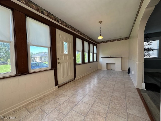 1905 Pine St SE, East Sparta, OH 44626 - unfurnished living room with arched walkways and baseboards