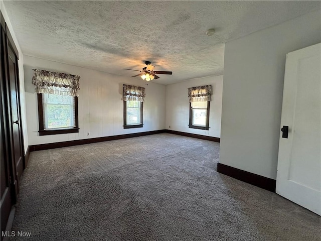 1905 Pine St SE, East Sparta, OH 44626 - carpeted spare room with a textured ceiling, baseboards, and a ceiling fan
