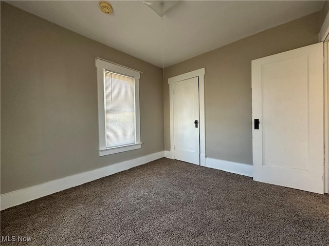 1905 Pine St SE, East Sparta, OH 44626 - empty room with dark colored carpet and baseboards