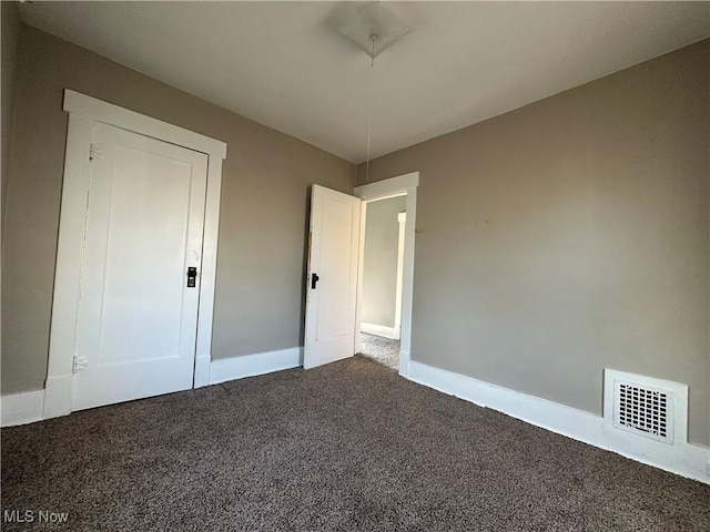 1905 Pine St SE, East Sparta, OH 44626 - unfurnished bedroom featuring carpet, baseboards, and visible vents