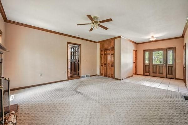 unfurnished living room featuring ornamental molding, light carpet, baseboards, and a ceiling fan