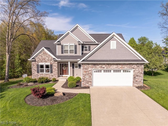 craftsman inspired home featuring a garage, a front yard, stone siding, and driveway