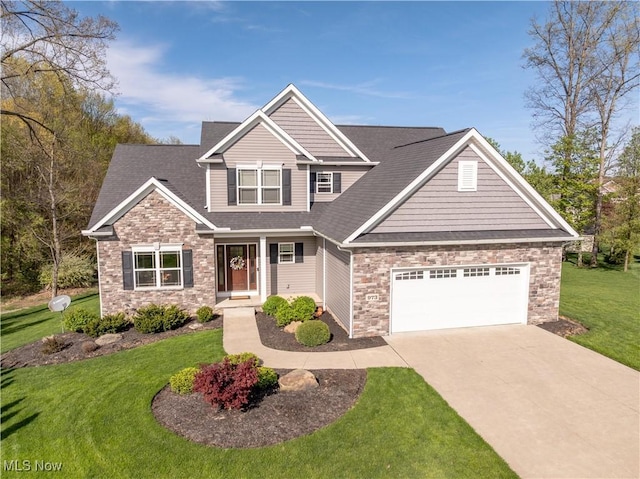 craftsman house with an attached garage, stone siding, driveway, a front lawn, and a shingled roof