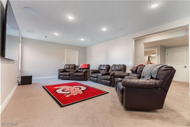 carpeted living room featuring baseboards and recessed lighting