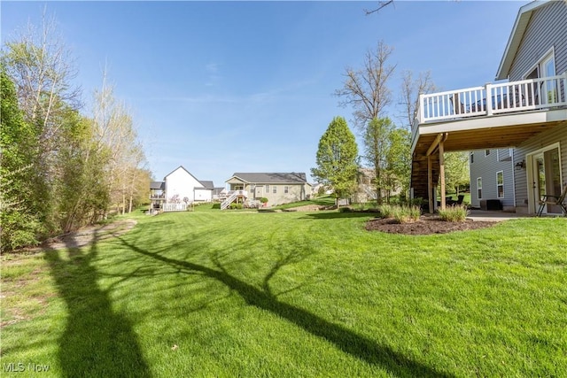 view of yard featuring stairway and a deck