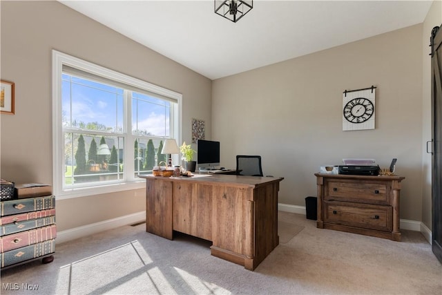 office area featuring light carpet and baseboards