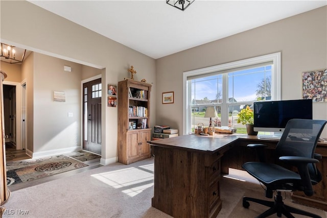 office with baseboards and light carpet