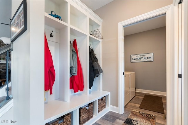 mudroom with separate washer and dryer, baseboards, and wood finished floors