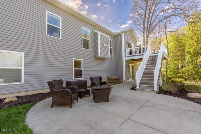 view of patio with a deck and stairs