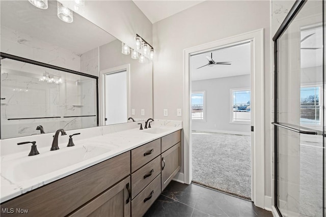 bathroom featuring double vanity, a sink, a healthy amount of sunlight, a shower stall, and ceiling fan