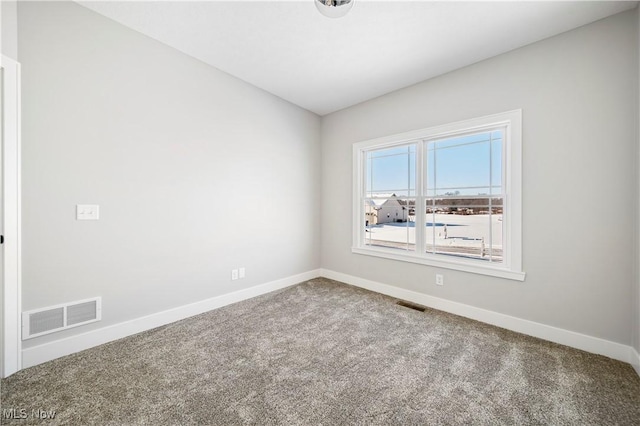 carpeted spare room with baseboards and visible vents