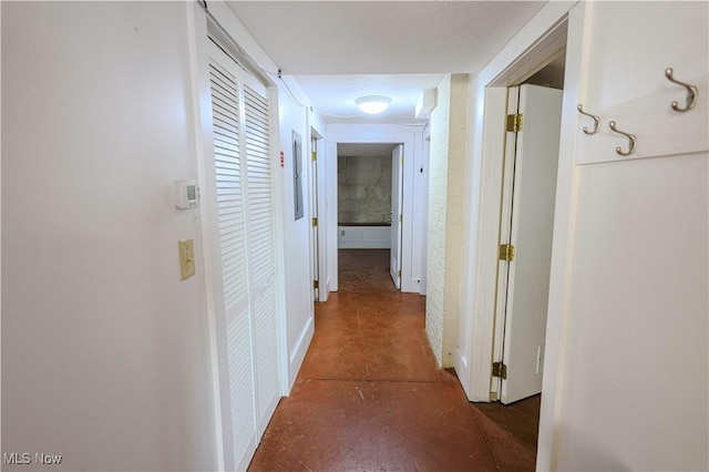 hall with concrete flooring