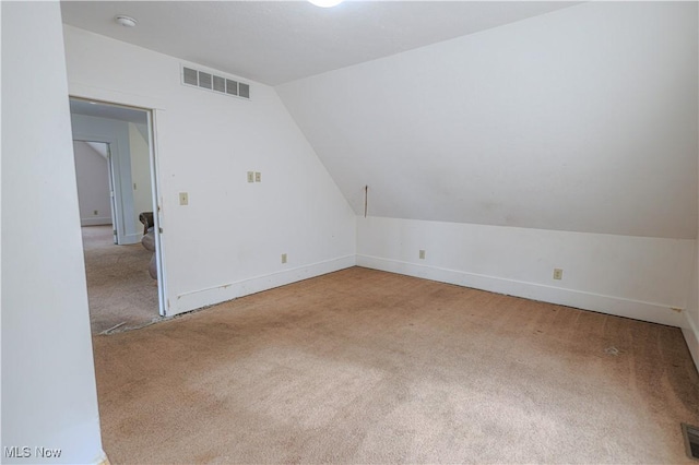 bonus room featuring lofted ceiling, carpet flooring, visible vents, and baseboards