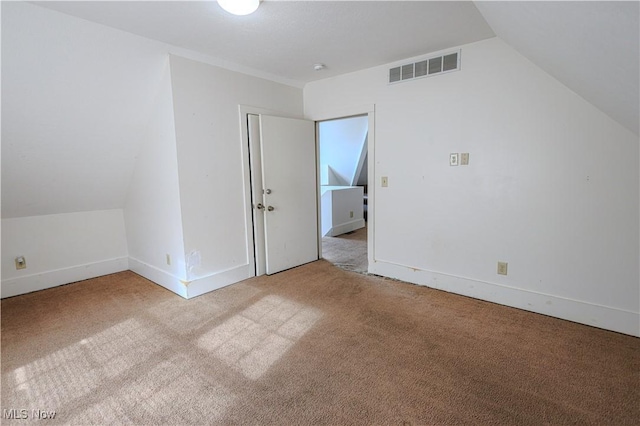bonus room featuring lofted ceiling, carpet flooring, visible vents, and baseboards