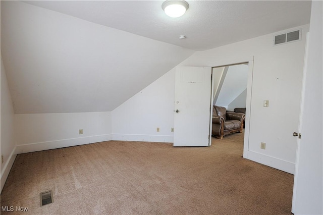 bonus room featuring baseboards, visible vents, carpet, and vaulted ceiling