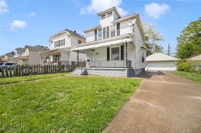 american foursquare style home with covered porch, an outdoor structure, fence, a garage, and a front yard