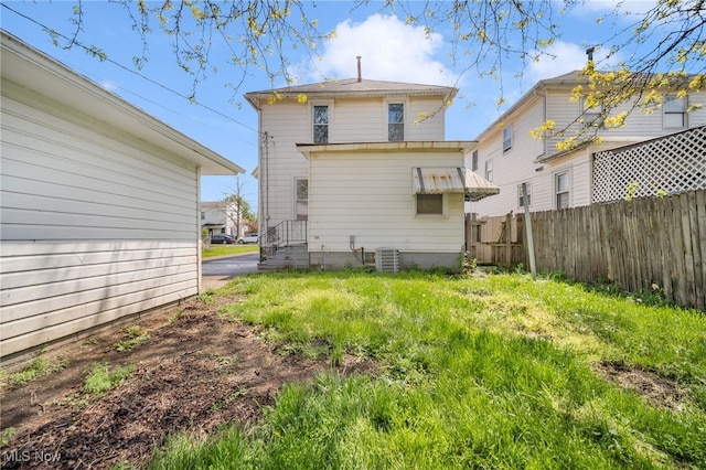 rear view of house featuring fence