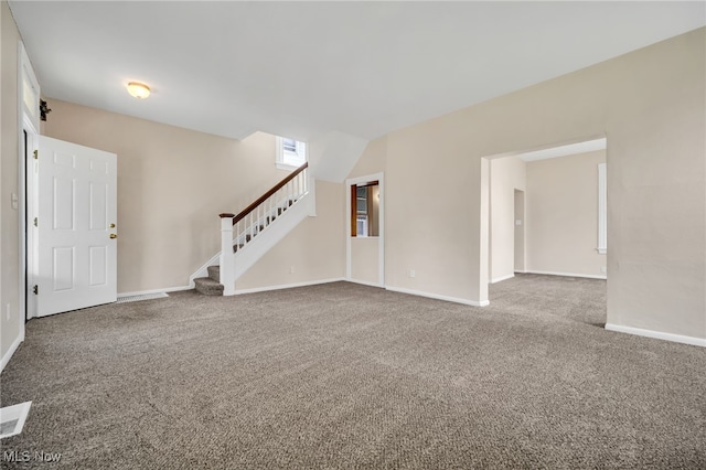 unfurnished living room featuring baseboards, stairway, visible vents, and carpet floors