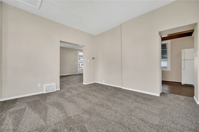 unfurnished room featuring carpet flooring, baseboards, and visible vents