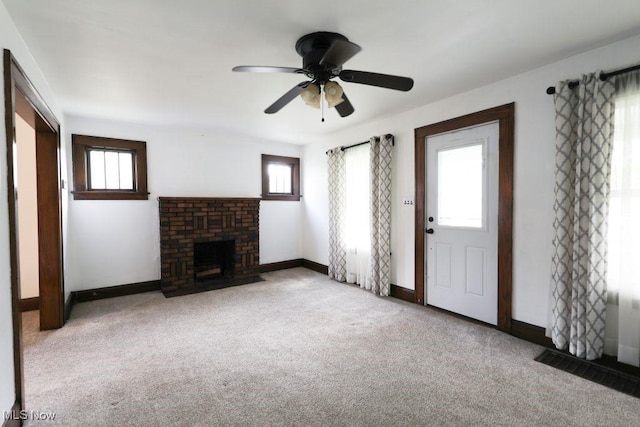unfurnished living room with baseboards, a healthy amount of sunlight, and carpet floors