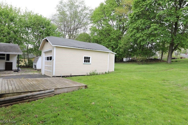 view of yard featuring an outbuilding and a detached garage
