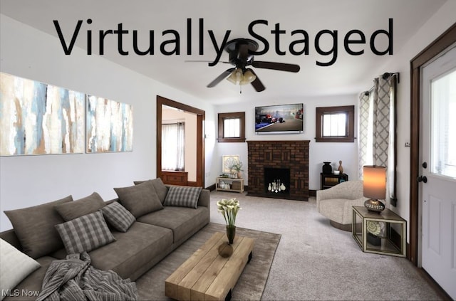 living area with a healthy amount of sunlight, a fireplace, ceiling fan, and carpet