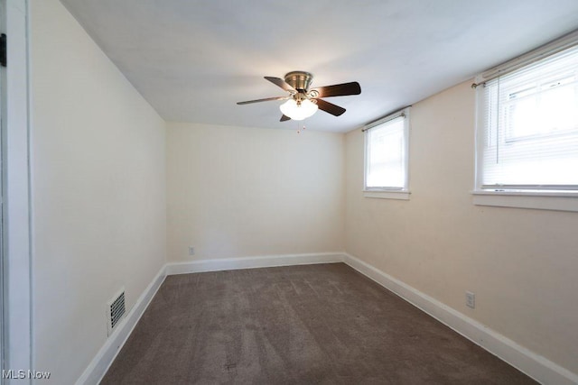 spare room featuring ceiling fan, carpet flooring, baseboards, and visible vents