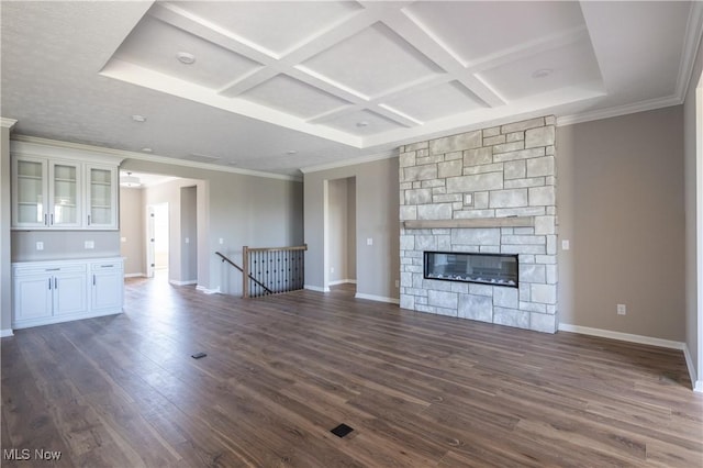 unfurnished living room featuring coffered ceiling, baseboards, a fireplace, and dark wood-style floors