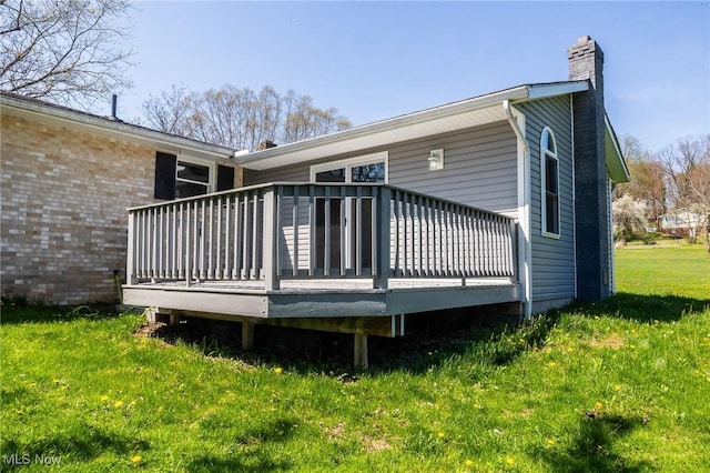 4820 Alabama Ave SW, Navarre, OH 44662 - rear view of house with a chimney, a deck, brick siding, and a yard